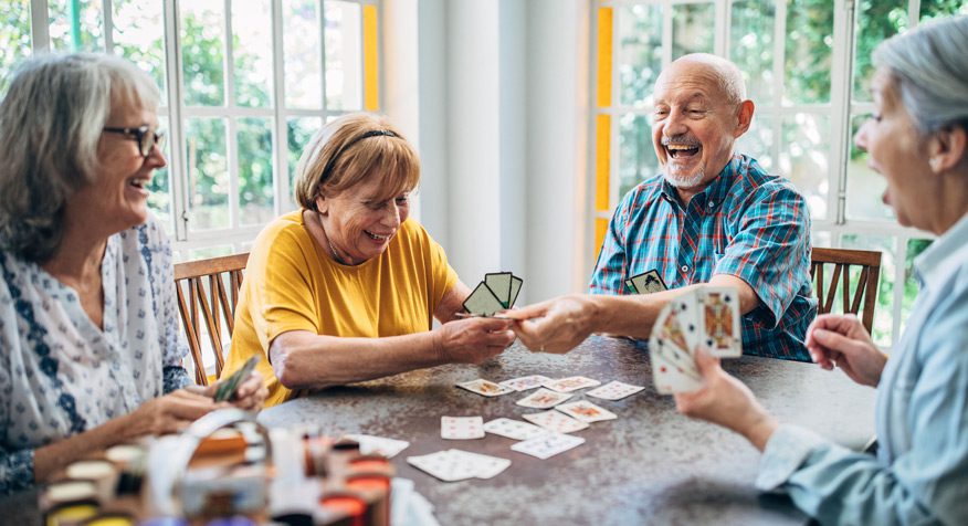 Seniors-playing-cards-in-a-retirement-community