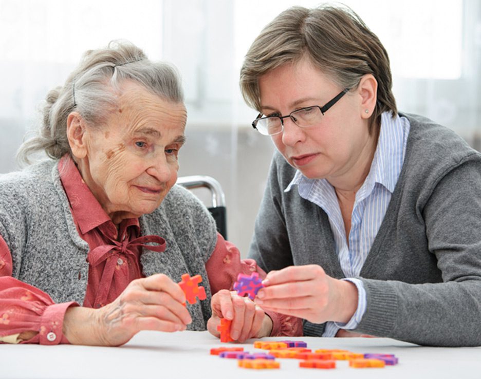 Elderly-woman-working-on-puzzle-at-facility-offering-memory-care-in-Simi-Valley