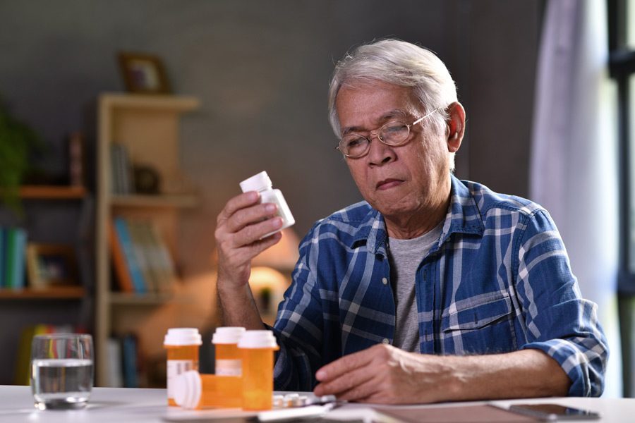 Senior-looking-at-his-medication