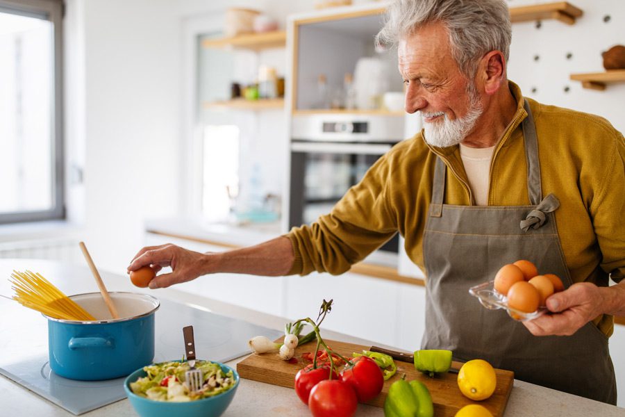Elderly-man-cooking-healthy-meal