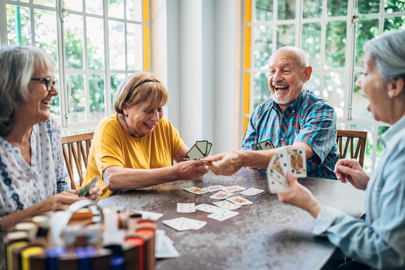 Elderly-individuals-playing-cards-at-assisted-living-in-Ventura-County Elderly-individuals-playing-cards-at-assisted-living-in-Ventura-County