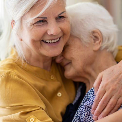 Woman-hugging-mother-in-facility-offering-memory-care-in-Camarillo Woman-hugging-mother-in-facility-offering-memory-care-in-Camarillo