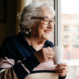 Elderly woman drinking coffe at home. Elderly woman drinking coffe at home.